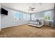 Spacious main bedroom featuring a ceiling fan, plantation shutters, and patterned accent wall at 3664 E Narrowleaf Dr, Gilbert, AZ 85298
