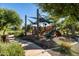 Community playground with slides, climbing structures, and shade covers for outdoor fun and recreation at 3664 E Narrowleaf Dr, Gilbert, AZ 85298