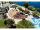 Aerial view of a community playground featuring swings, climbing structures, and a nearby splash pad at 3664 E Narrowleaf Dr, Gilbert, AZ 85298