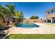 Backyard with swimming pool, featuring rock waterfall, basketball hoop and lush landscaping at 3664 E Narrowleaf Dr, Gilbert, AZ 85298