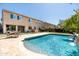 A view of the backyard and pool with water feature, patio, lush lawn, and house exterior at 3664 E Narrowleaf Dr, Gilbert, AZ 85298