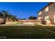 A backyard with a pool features lush landscaping, an outdoor kitchen and seating areas at 3664 E Narrowleaf Dr, Gilbert, AZ 85298