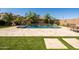 Pool with waterfall feature, lush turf, and a travertine patio at 3664 E Narrowleaf Dr, Gilbert, AZ 85298