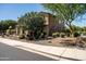 Side view of a well-maintained home with desert landscaping and mature trees providing shade at 3664 E Narrowleaf Dr, Gilbert, AZ 85298