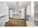 Spacious walk-in closet with white cabinets, shelving, and drawers for ample storage, illuminated by a modern chandelier at 3664 E Narrowleaf Dr, Gilbert, AZ 85298