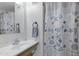Cozy bathroom featuring a sink with a modern faucet and a charming shower curtain with a nautical design at 4065 E University Dr # 332, Mesa, AZ 85205