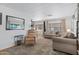 Open living room with laminate floors, seating, and a comfortable recliner at 4065 E University Dr # 332, Mesa, AZ 85205