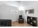 Bright living room with wood-look flooring, natural light, and a comfortable recliner for relaxation at 4065 E University Dr # 332, Mesa, AZ 85205