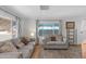Bright living room features laminate flooring, neutral paint, and comfortable seating at 4065 E University Dr # 332, Mesa, AZ 85205