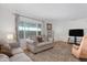 Living room featuring seating area, laminate flooring, and a television for entertainment at 4065 E University Dr # 332, Mesa, AZ 85205