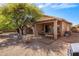 Inviting backyard with desert landscaping, covered patio, seating areas, and mature trees at 4117 E Molly Ln, Cave Creek, AZ 85331