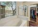 Well-lit bathroom with a clear glass shower, soaking tub, and a view of a walk-in closet at 4117 E Molly Ln, Cave Creek, AZ 85331