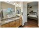 Bathroom featuring double sinks, granite countertops, and a view into an adjacent bedroom at 4117 E Molly Ln, Cave Creek, AZ 85331