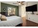 Green accent wall in the bedroom featuring a desk by the window, and view to bathroom at 4117 E Molly Ln, Cave Creek, AZ 85331