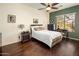 Comfortable bedroom with hardwood floors, ceiling fan, desk area, and modern decor elements at 4117 E Molly Ln, Cave Creek, AZ 85331