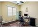 Cozy bedroom with hardwood floors, a desk area, and a mini fridge at 4117 E Molly Ln, Cave Creek, AZ 85331