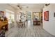 Open-concept dining room boasting distressed floors, natural light, and vintage-style decor at 4117 E Molly Ln, Cave Creek, AZ 85331