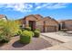 Attractive single-story tan home with a well-kept front yard and three-car garage under a partly cloudy sky at 4117 E Molly Ln, Cave Creek, AZ 85331