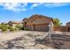 Tan home featuring a three-car garage and well-manicured gravel landscaping under a bright blue, partly cloudy sky at 4117 E Molly Ln, Cave Creek, AZ 85331