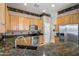 Well-lit kitchen featuring stainless steel appliances, granite countertops, and beautiful wallpaper at 4117 E Molly Ln, Cave Creek, AZ 85331