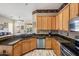Well-lit kitchen features wood cabinetry, dark countertops, and modern stainless steel appliances at 4117 E Molly Ln, Cave Creek, AZ 85331