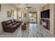 Bright living room featuring tile floors, a fireplace, and sliding door access to the backyard at 4117 E Molly Ln, Cave Creek, AZ 85331