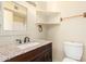 Bathroom featuring dark wood vanity, granite counters, sink, toilet and mirrored medicine cabinet at 4219 W Pasadena Ave, Phoenix, AZ 85019