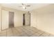 Neutral bedroom with tile flooring, closet, and ceiling fan for comfort at 4219 W Pasadena Ave, Phoenix, AZ 85019
