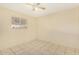 Cozy bedroom with tile floors, neutral paint, and a window for natural light at 4219 W Pasadena Ave, Phoenix, AZ 85019