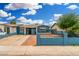 Charming blue single-story home with a well-kept front yard and black iron fence at 4219 W Pasadena Ave, Phoenix, AZ 85019