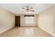 Inviting living room with a large window, tile floors, and a ceiling fan at 4219 W Pasadena Ave, Phoenix, AZ 85019