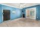 Enclosed patio featuring blue walls, concrete floor and ceiling fan at 4219 W Pasadena Ave, Phoenix, AZ 85019