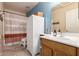 Bright bathroom featuring an ample vanity, linen cabinet and a tub with shower at 4702 N 124Th Ave, Avondale, AZ 85392