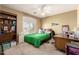 Cozy bedroom featuring a ceiling fan, carpeted floor, and window offering natural light at 4702 N 124Th Ave, Avondale, AZ 85392