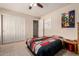 Cozy bedroom featuring a large window, ceiling fan, and plenty of closet space at 4702 N 124Th Ave, Avondale, AZ 85392