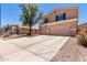 Two-story home with large concrete driveway and desert landscaping at 4702 N 124Th Ave, Avondale, AZ 85392