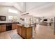 Spacious kitchen with an island, modern lighting, and an open floor plan to the living room at 4702 N 124Th Ave, Avondale, AZ 85392