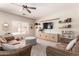 Comfortable living room with a brown sectional sofa and ample natural light at 4702 N 124Th Ave, Avondale, AZ 85392