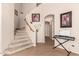 A staircase with carpeted steps, arched doorway, and decor touches adding character to the foyer at 4702 N 124Th Ave, Avondale, AZ 85392