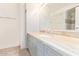 Bathroom vanity with light marble countertop, gray cabinetry, and a large mirror at 4808 N 24Th St # 230, Phoenix, AZ 85016