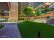 Lush courtyard with green lawn, trees, landscaping and exterior building at 4808 N 24Th St # 230, Phoenix, AZ 85016