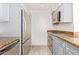 The kitchen features stainless steel appliances, granite countertops and tile flooring at 4808 N 24Th St # 230, Phoenix, AZ 85016
