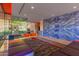 Modern lobby with bold accent wall, seating, and glass doors to the exterior at 4808 N 24Th St # 230, Phoenix, AZ 85016
