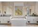 Elegant bathroom with a large soaking tub, dual sinks, and decorative backsplash at 5420 E Duane Ln, Cave Creek, AZ 85331
