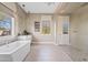 Bright bathroom features a freestanding tub, glass shower, and tiled flooring at 5420 E Duane Ln, Cave Creek, AZ 85331