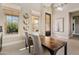 Bright dining area with tall ceilings, modern lighting, and picturesque backyard views through large windows at 5420 E Duane Ln, Cave Creek, AZ 85331