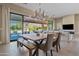 Bright dining room featuring a wooden table, stylish chairs, and large sliding doors leading to an outdoor patio at 5420 E Duane Ln, Cave Creek, AZ 85331