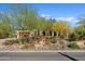 Charming single-story home surrounded by lush desert landscaping, mature trees, and a stone driveway, showcasing curb appeal at 5420 E Duane Ln, Cave Creek, AZ 85331