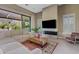 Cozy living room boasts a plush sectional sofa, fireplace, large windows, and access to the outdoor patio at 5420 E Duane Ln, Cave Creek, AZ 85331