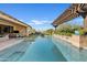 Inviting backyard pool with pergola, water feature, and lush desert landscaping for relaxation and outdoor enjoyment at 5420 E Duane Ln, Cave Creek, AZ 85331